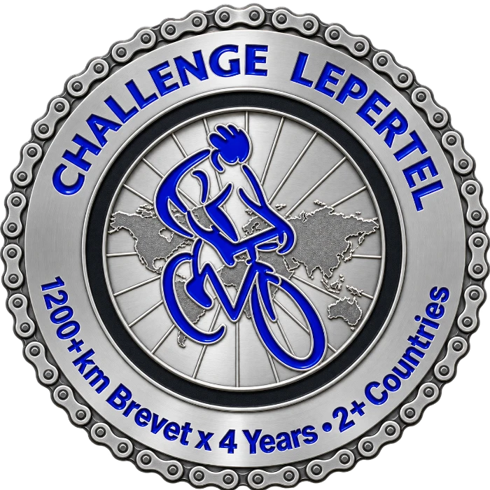 The Challenge Lepertel medal from Les Randonneurs Mondiaux: a blue rider over a map of the world inside a chain-link rim, with “1200+km Brevet × 4 Years • 2+ Countries” around it