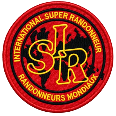 The International Super Randonneur patch, a red embroidered disc with a gold ISR monogram over a map of the world